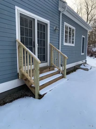 Exterior wooden stair installation angled perspective showing pressure-treated wood.