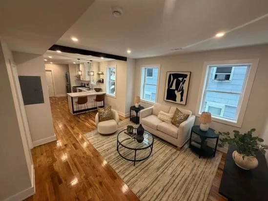 Multifamily Renovation Project showcasing open living space with hardwood floors and updated finishes