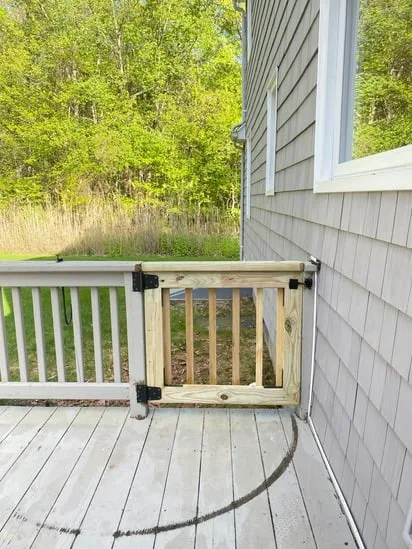 A newly installed wood gate as part of a deck structural repair project.